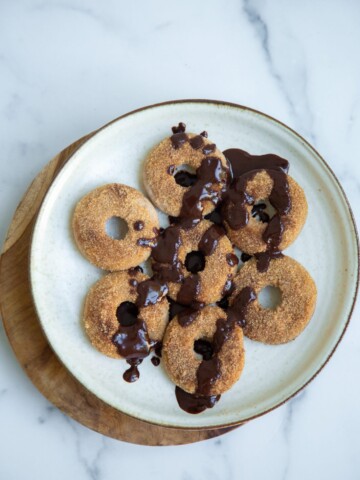 vegan churro donuts with a chocolate drizzle