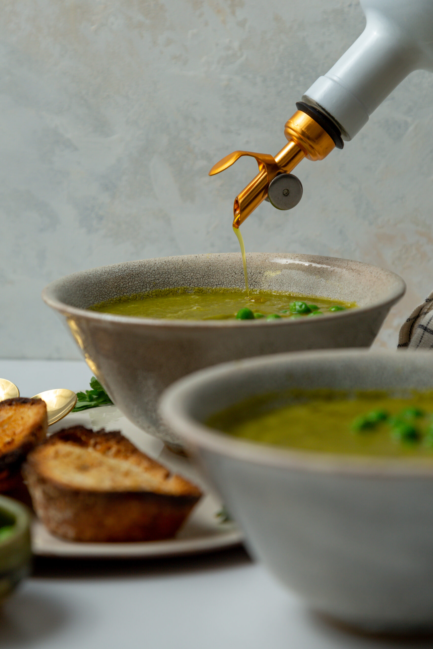olive oil drizzle on healthy green soup
