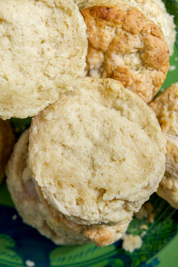 Close-up of stacked sourdough discard biscuits highlighting golden flaky layers