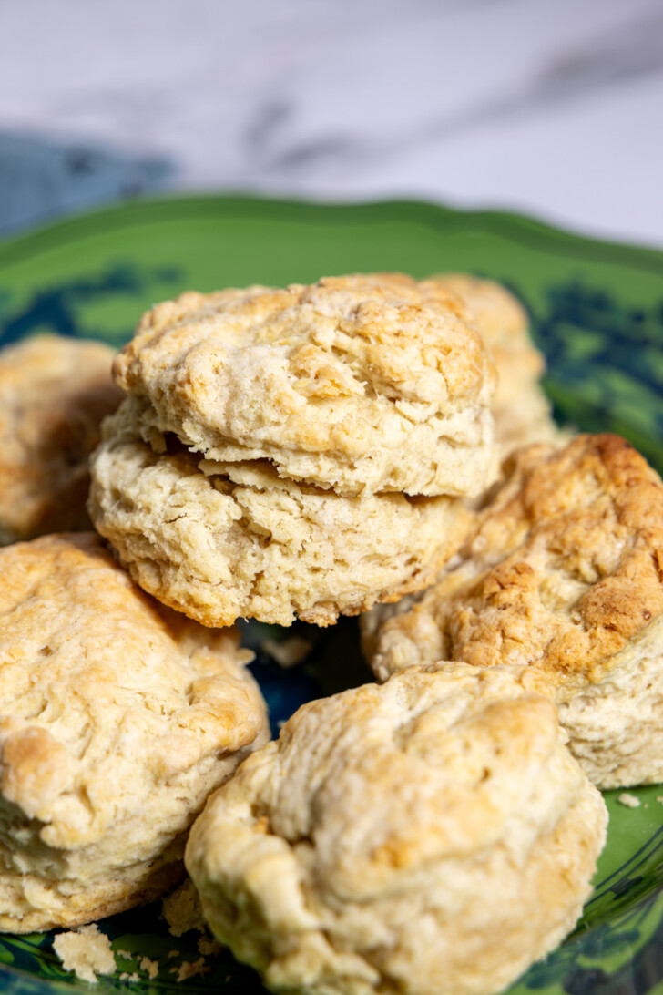 Plate of freshly baked vegan sourdough discard biscuits arranged in a rustic serving bowl